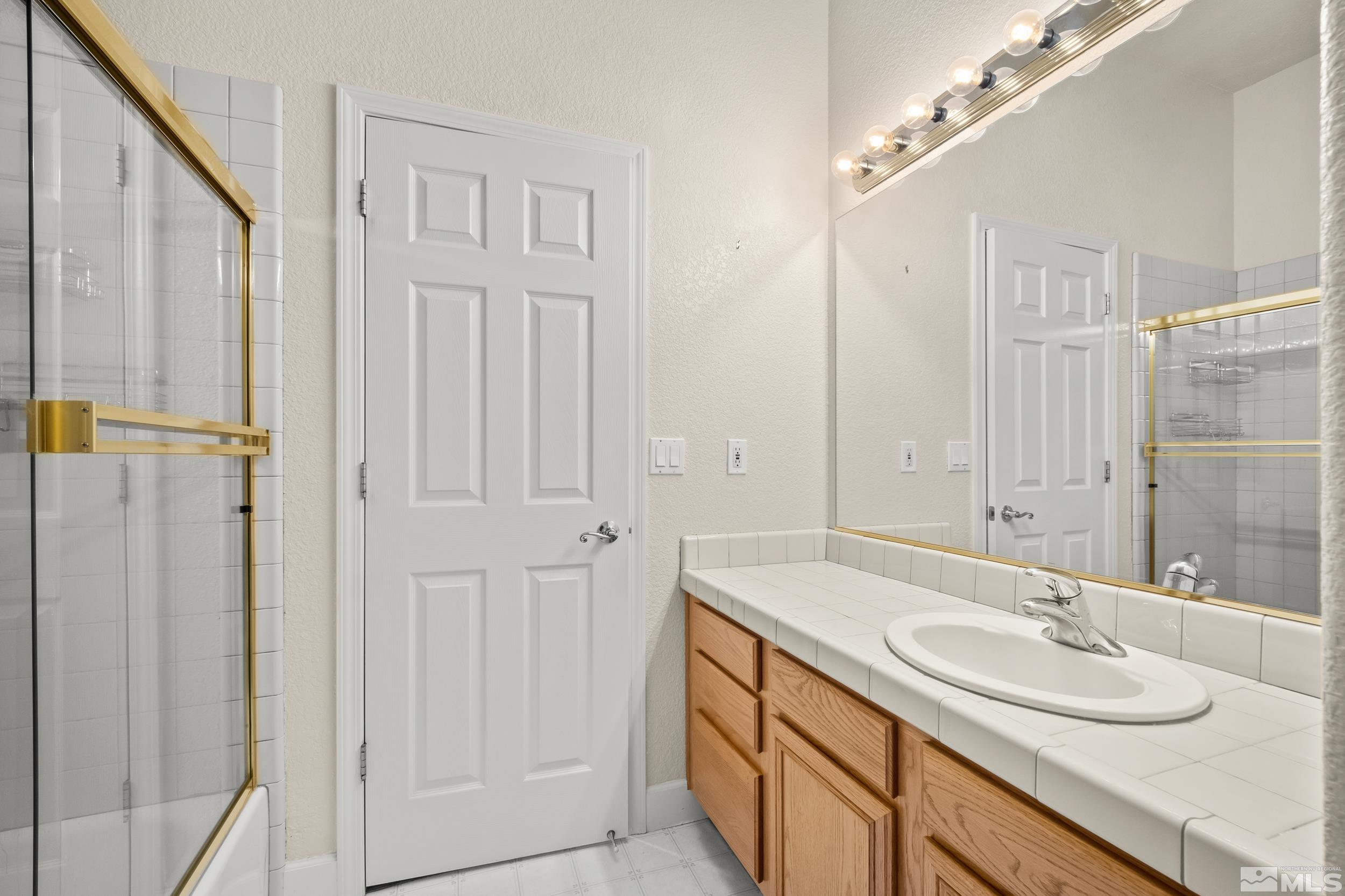 3463 Long Drive Minden, NV 89423 - Photo 17 of 40 a bathroom with a sink double vanity and a mirror