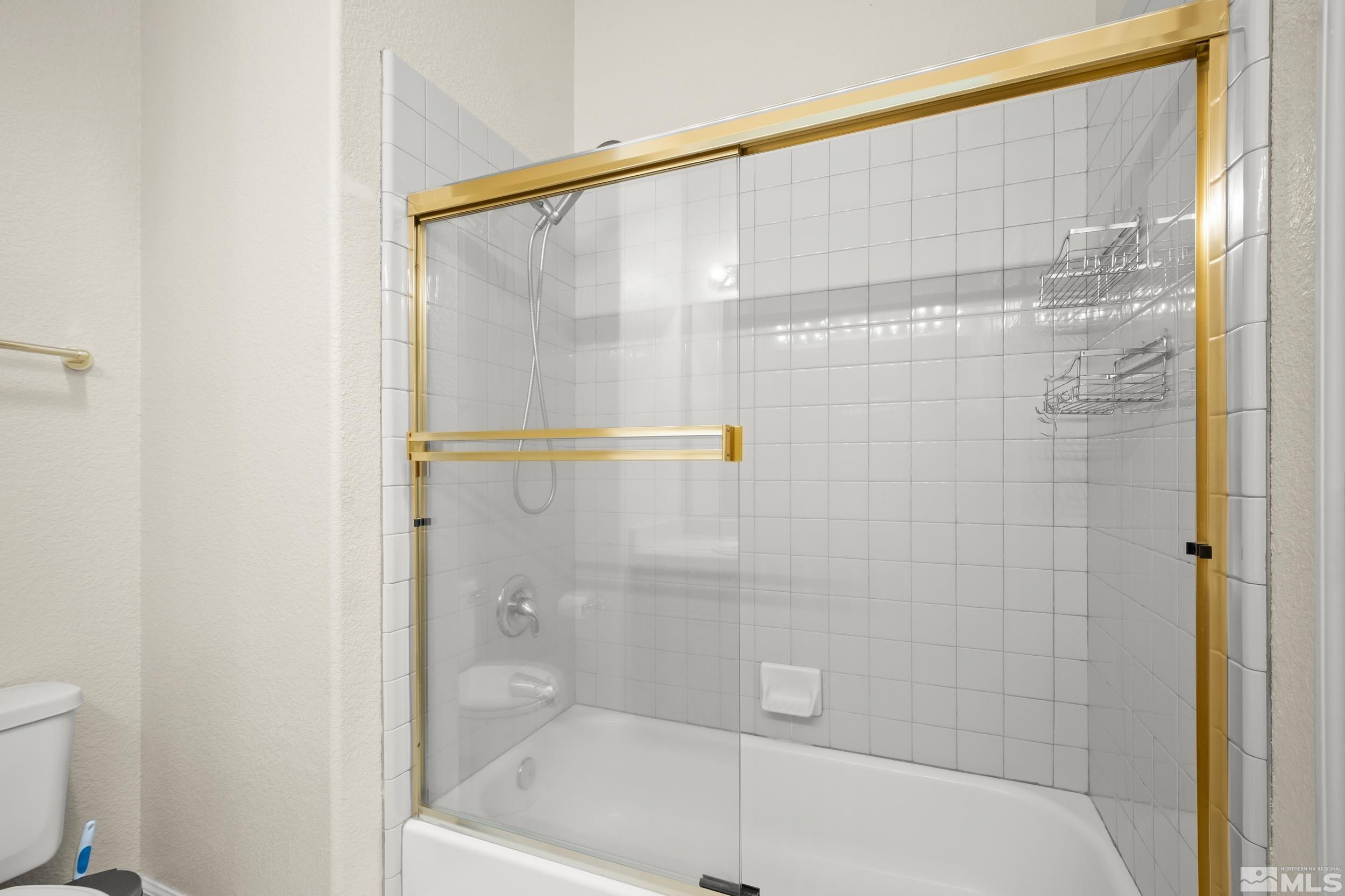 3463 Long Drive Minden, NV 89423 - Photo 18 of 40 a bathroom with a shower and a bath tub