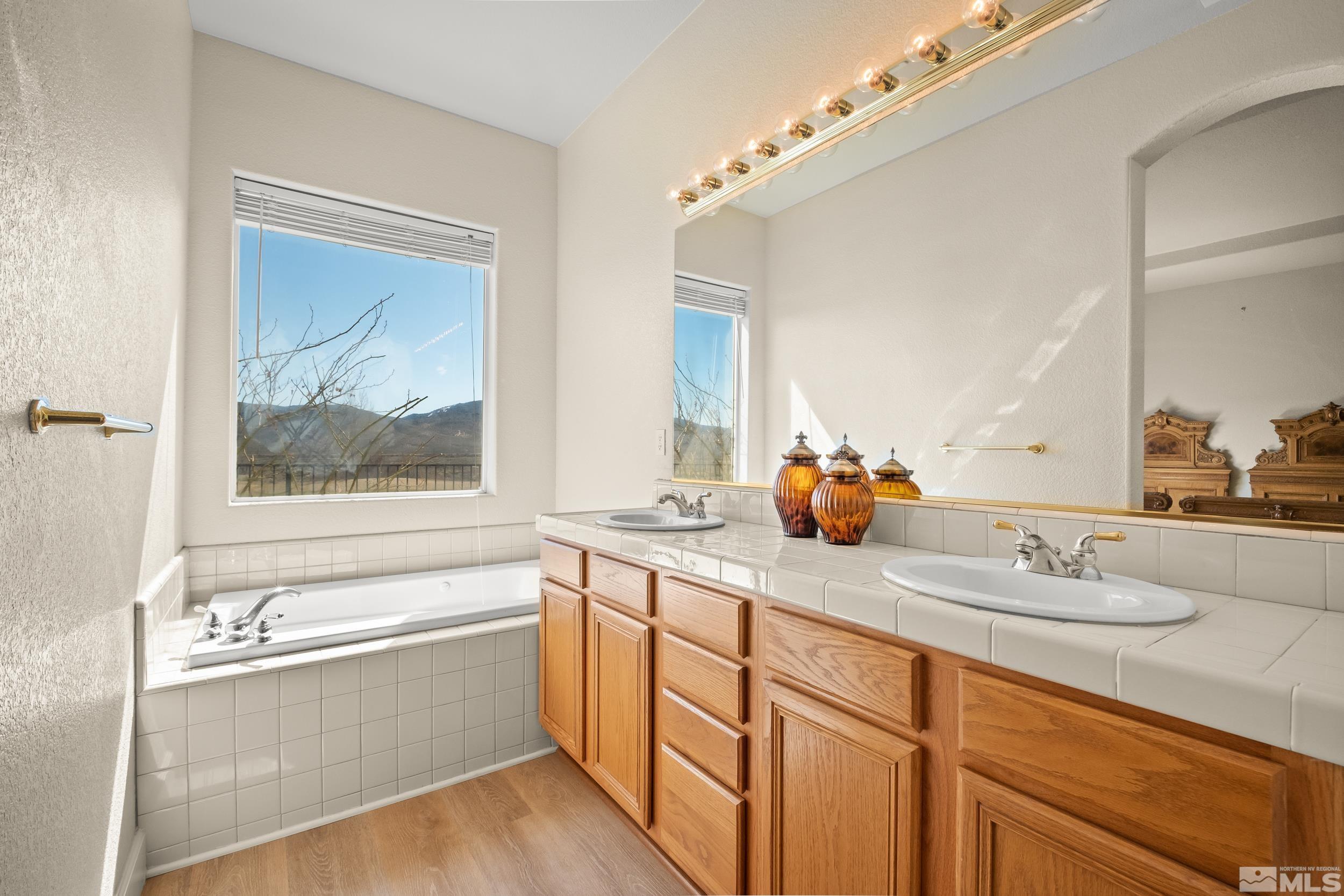 3463 Long Drive Minden, NV 89423 - Photo 22 of 40 a bathroom with a sink and a large mirror