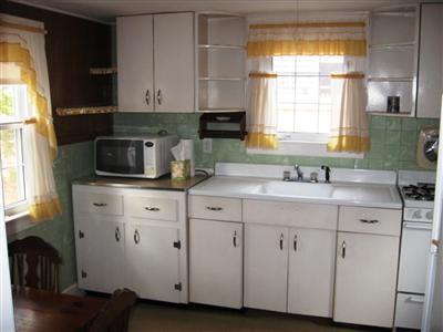 10 Silverleaf Lane West Yarmouth, MA 02673 - Photo 10 of 12 a kitchen with white cabinets and a sink
