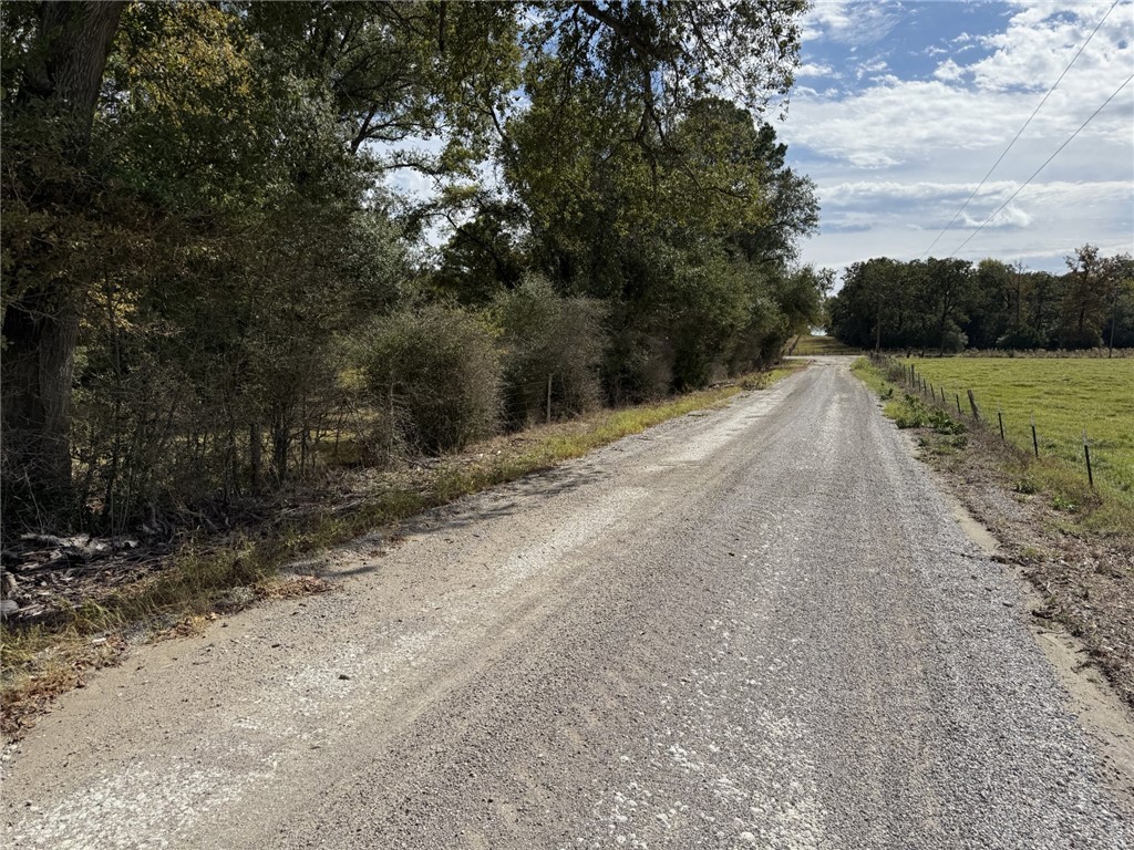 5878 East Boone Prairie Road, Unit COUNTYROAD Franklin, TX 77856 - Photo 39 of 42 a view of a road with a yard