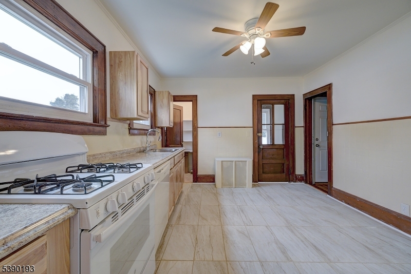 24 Brook Street Springfield, NJ 07081 - Photo 11 of 28 a kitchen with stainless steel appliances granite countertop a stove a refrigerator and a cabinets