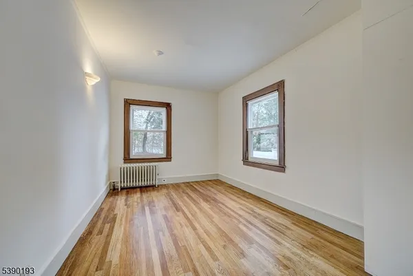 a view of an empty room with glass window and closet area