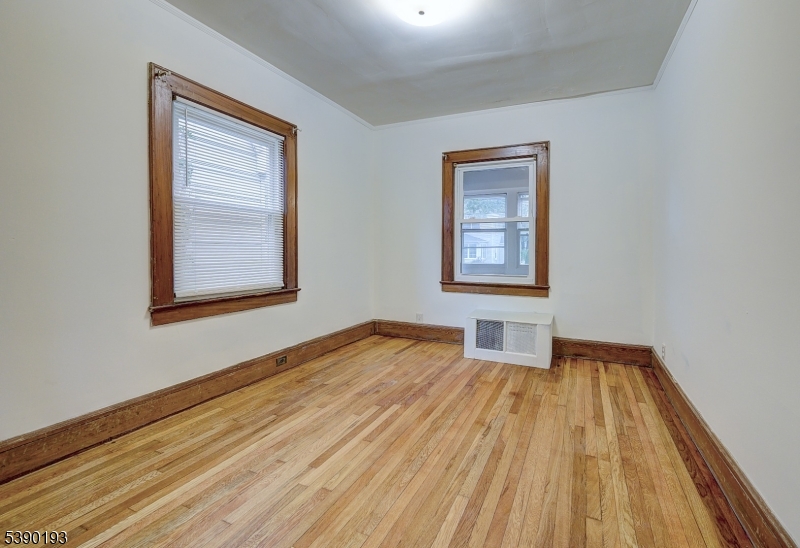 24 Brook Street Springfield, NJ 07081 - Photo 15 of 28 a view of an empty room with window and wooden floor