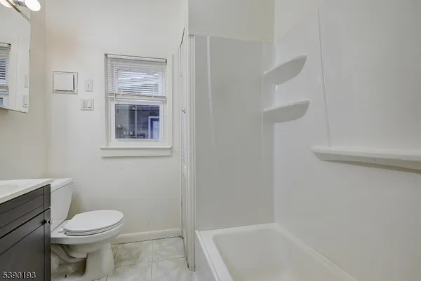 a bathroom with a toilet and a bathtub
