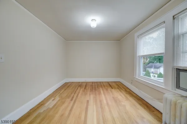 a view of a room with wooden floor and windows