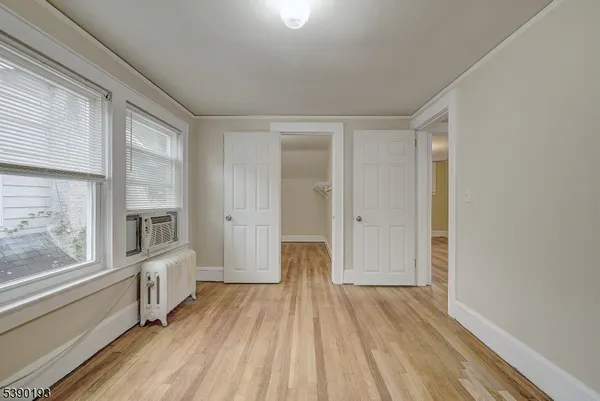 a view of a room with wooden floor and windows
