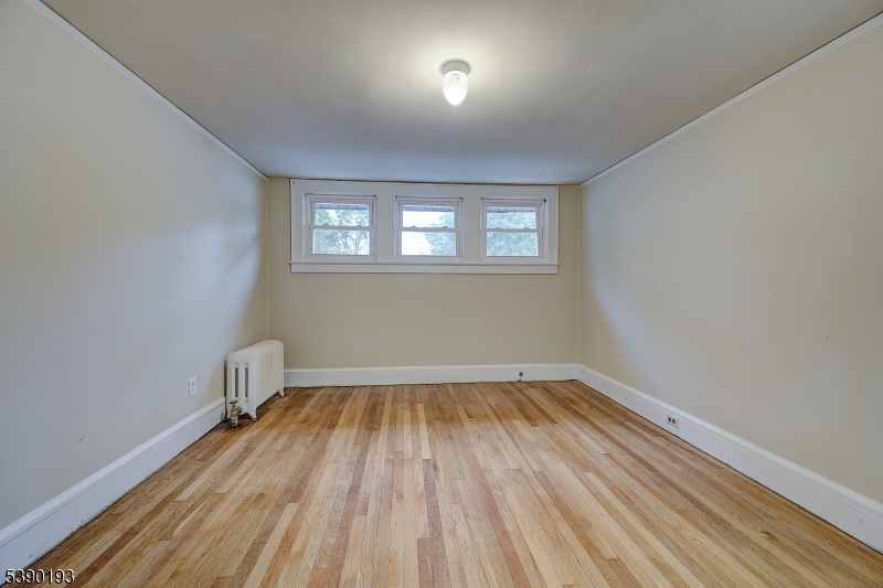 24 Brook Street Springfield, NJ 07081 - Photo 19 of 28 a view of a room with wooden floor and windows