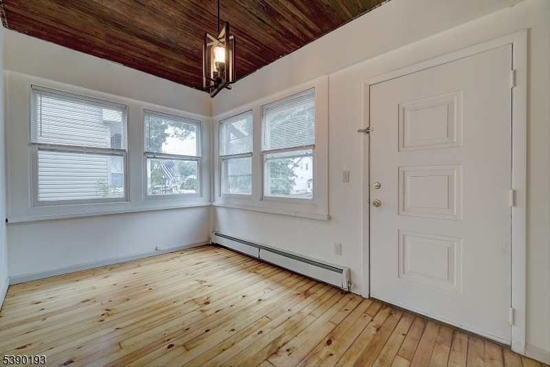 24 Brook Street Springfield, NJ 07081 - Photo 2 of 28 a view of empty room with wooden floor and fan