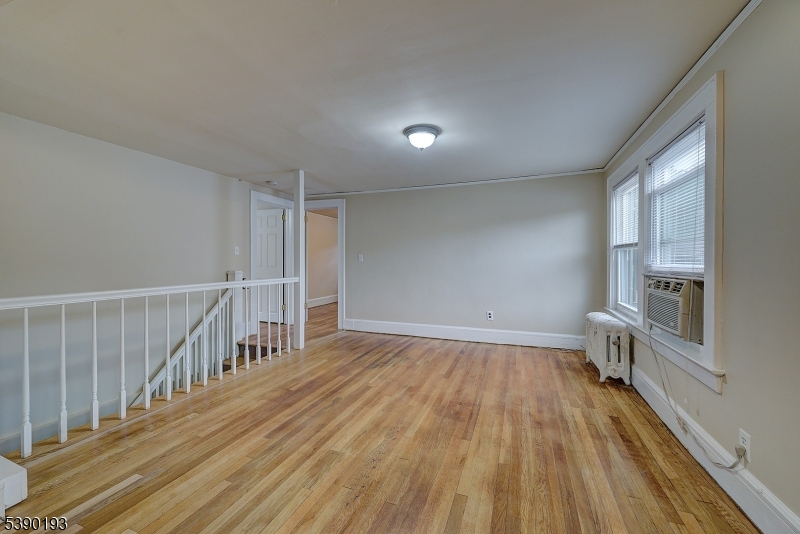24 Brook Street Springfield, NJ 07081 - Photo 21 of 28 wooden floor in an empty room with a window