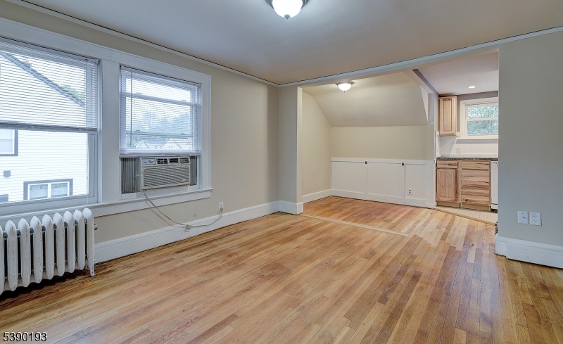 24 Brook Street Springfield, NJ 07081 - Photo 22 of 28 an empty room with wooden floor and windows