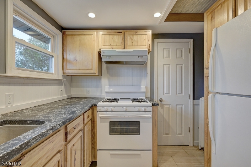 24 Brook Street Springfield, NJ 07081 - Photo 25 of 28 a kitchen with granite countertop cabinets stainless steel appliances and a sink