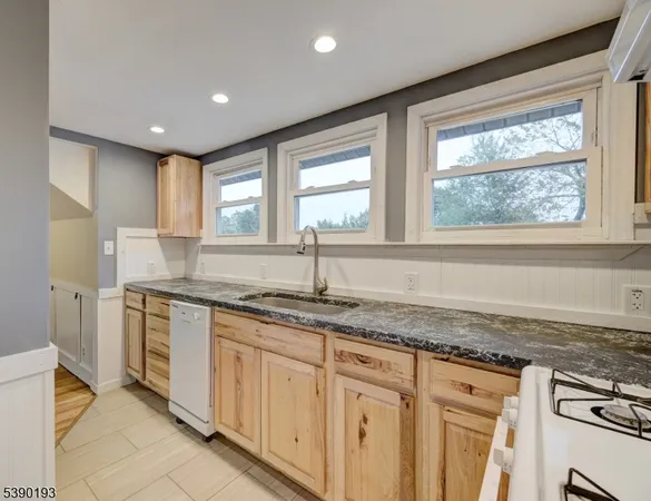 a kitchen with granite countertop a sink and a window