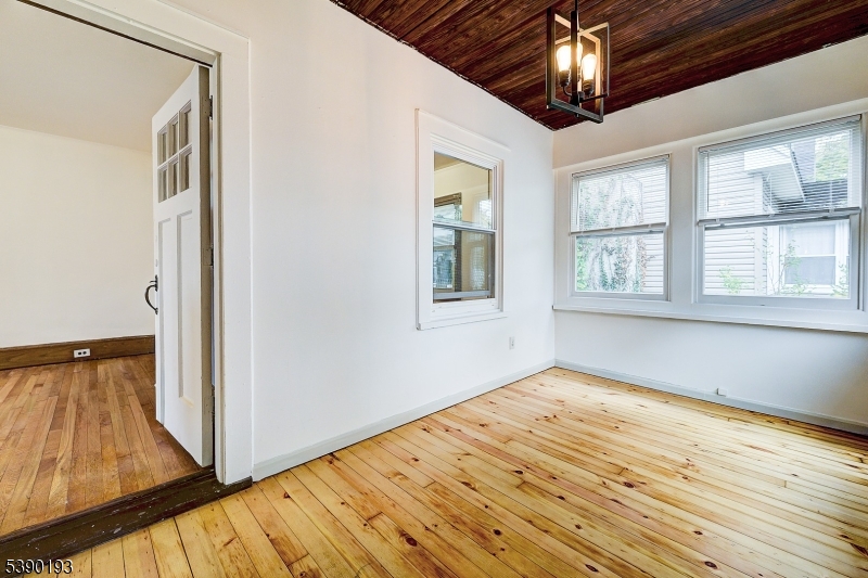 24 Brook Street Springfield, NJ 07081 - Photo 3 of 28 a view of an empty room with wooden floor and a window