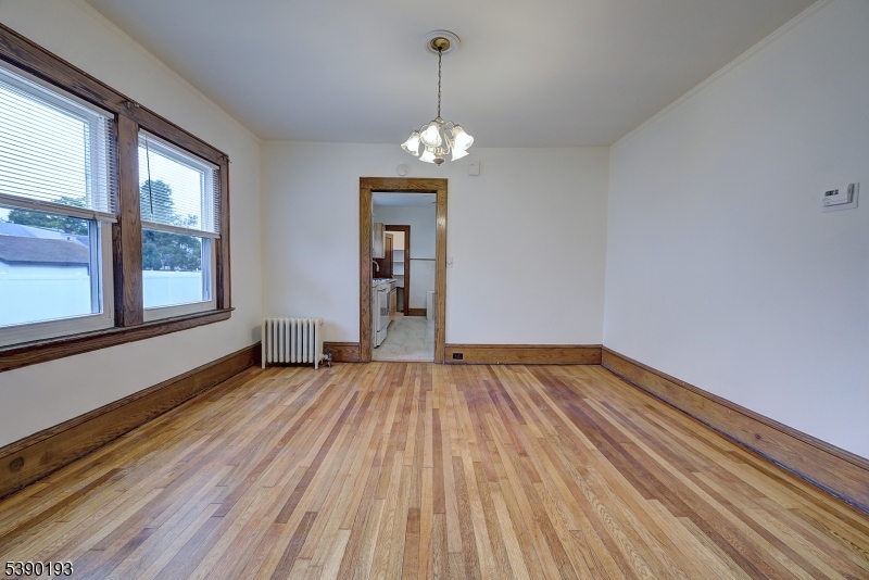 24 Brook Street Springfield, NJ 07081 - Photo 8 of 28 a view of empty room with wooden floor and fan