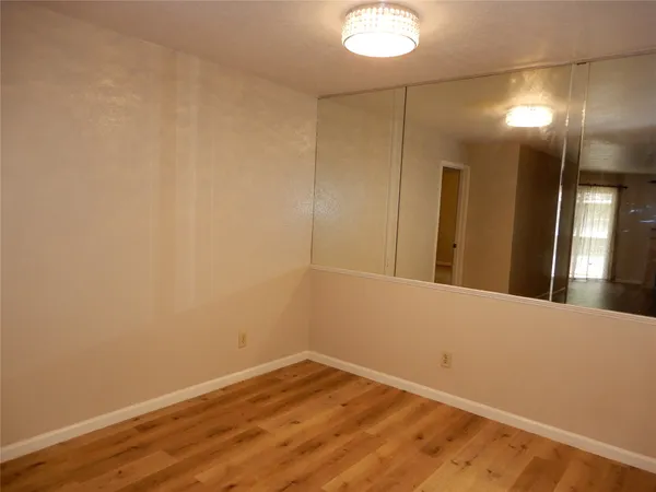 a view of a room with wooden floor and brick walls