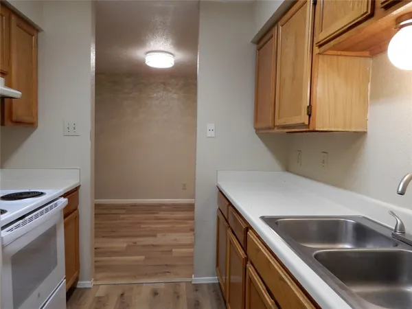 a kitchen with a sink and a refrigerator