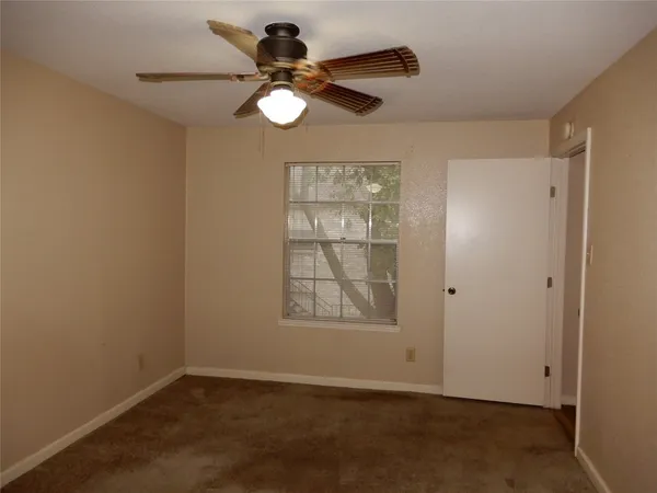 an empty room with window and wooden floor