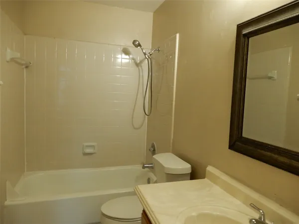 a bathroom with a toilet and shower