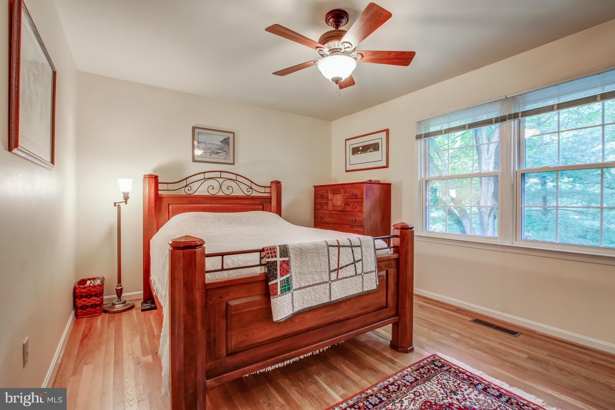 1814 Cranberry Lane Reston, VA 20191 - Photo 19 of 30 a bedroom with a bed and a chandelier