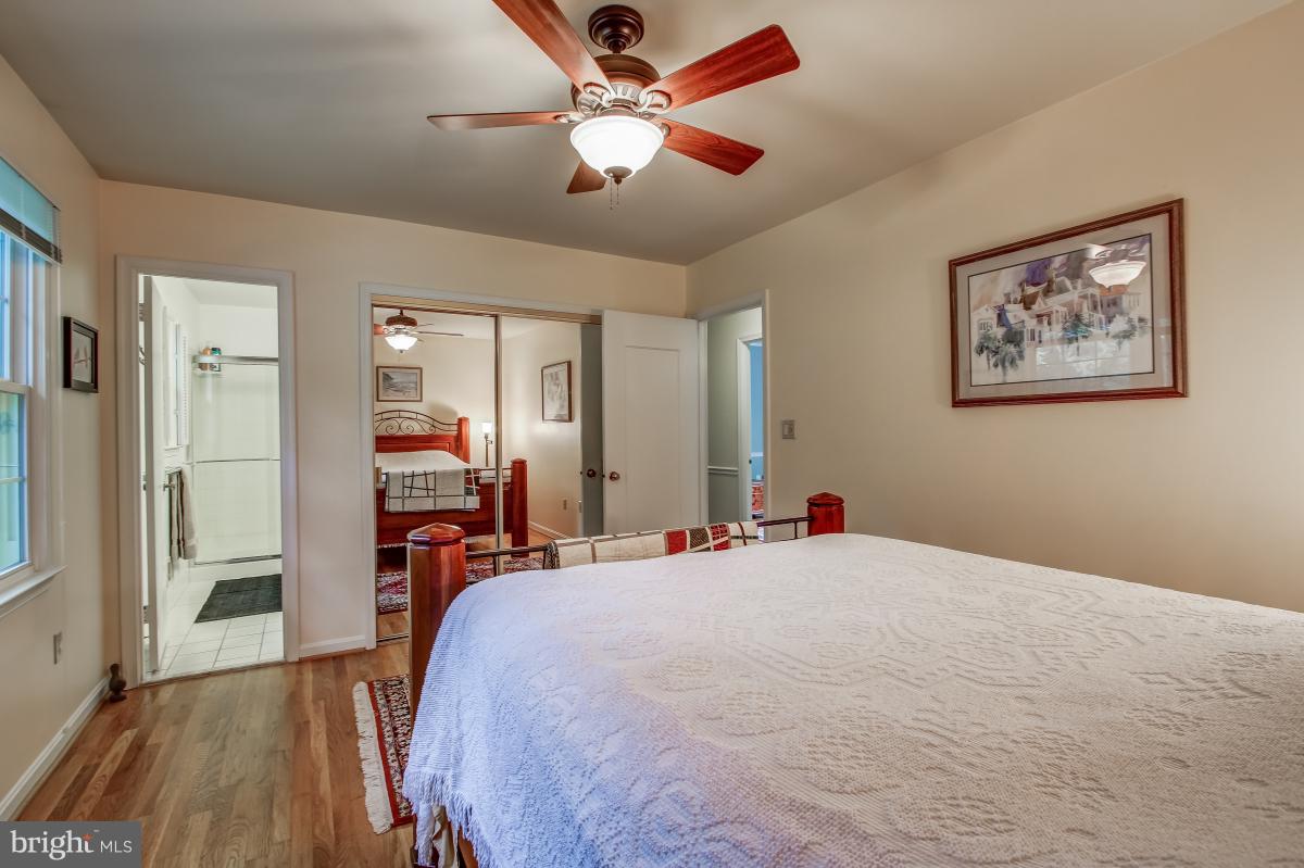 1814 Cranberry Lane Reston, VA 20191 - Photo 20 of 30 a bed room with a bed and a chandelier