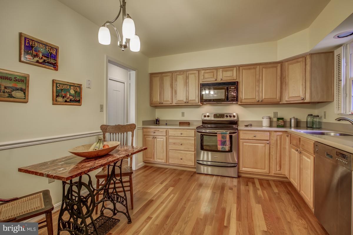 1814 Cranberry Lane Reston, VA 20191 - Photo 10 of 30 a kitchen with granite countertop wooden floors and white appliances