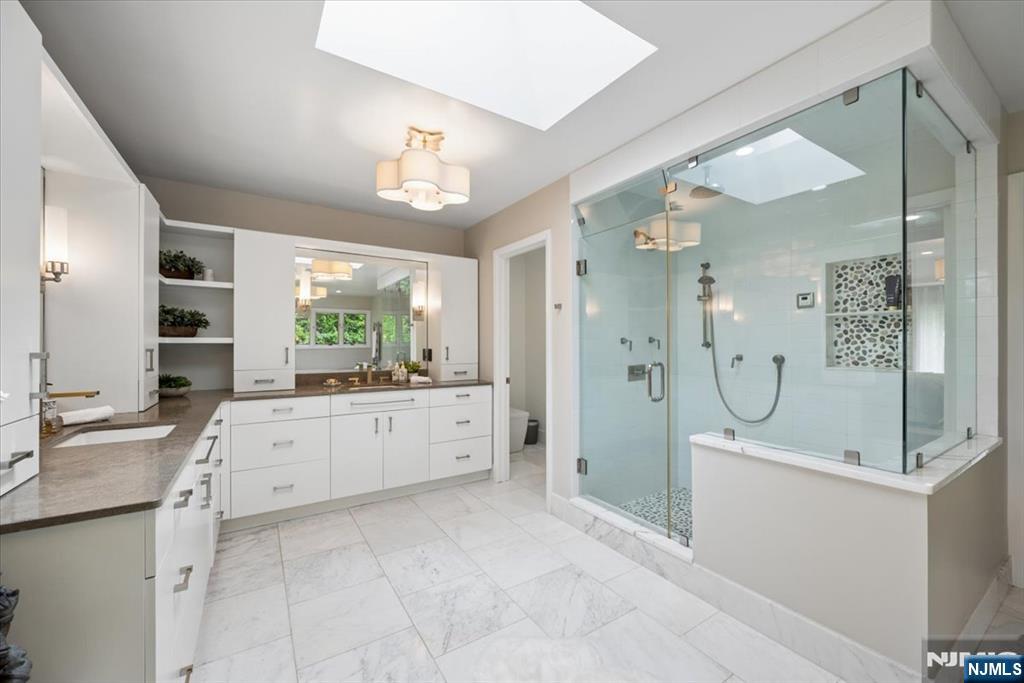39 Eagle Nest Road Morris Township, NJ 07960 - Photo 24 of 43 a large bathroom with a granite countertop sink mirror and shower