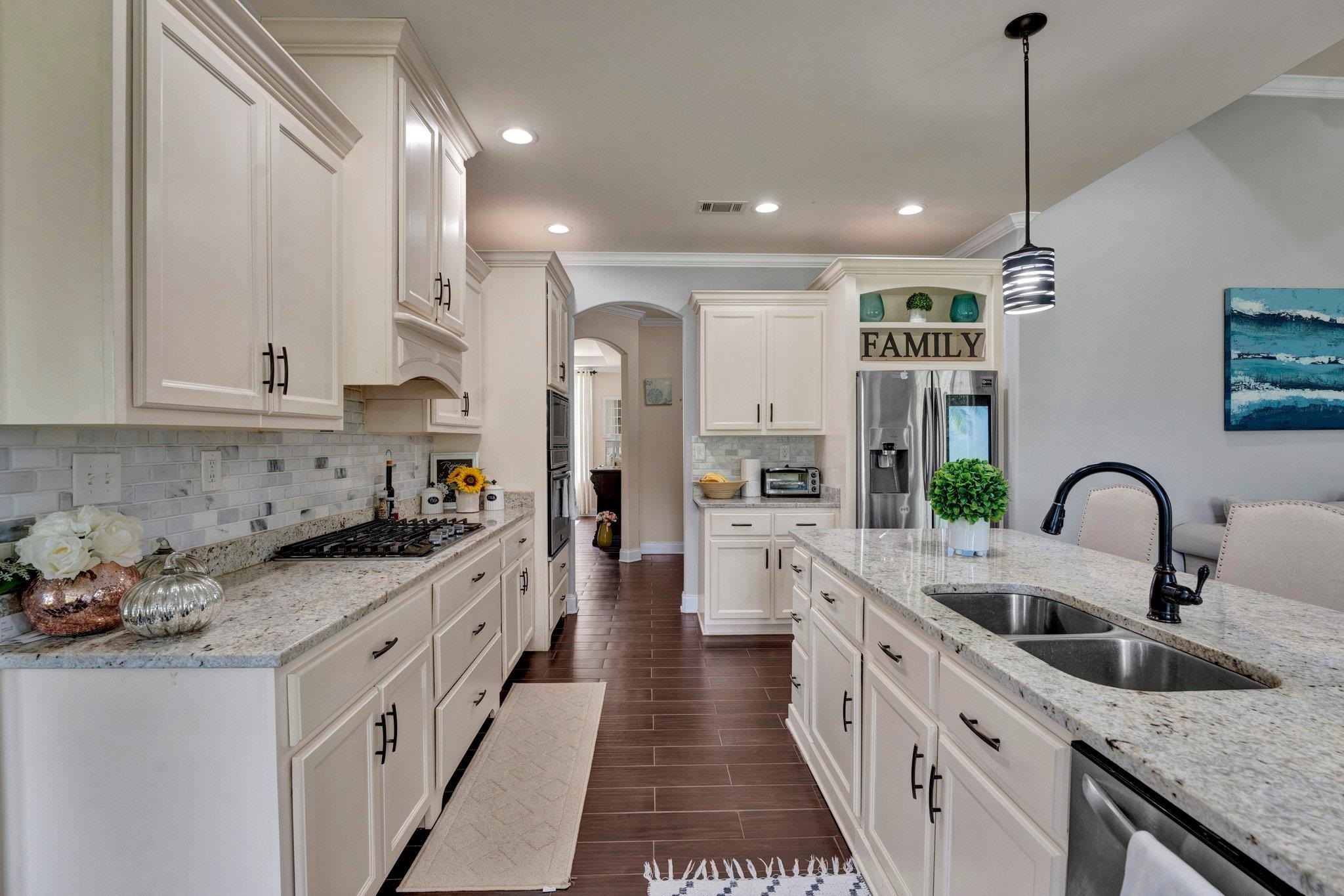 3270 Rast Road Millington, TN 38053 - Photo 12 of 40 Kitchen with open shelves, arched walkways, decorative light fixtures, light stone countertops, and appliances with stainless steel finishes