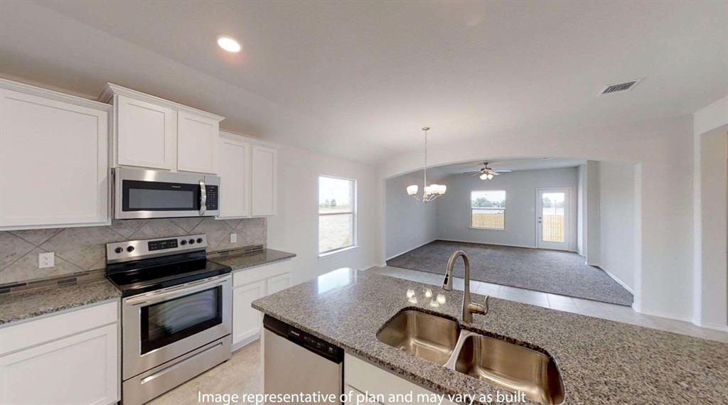 5800 Foggy Lagoon Drive Waco, TX 76708 - Photo 9 of 24 a kitchen with granite countertop a sink and a stove top oven with granite countertops