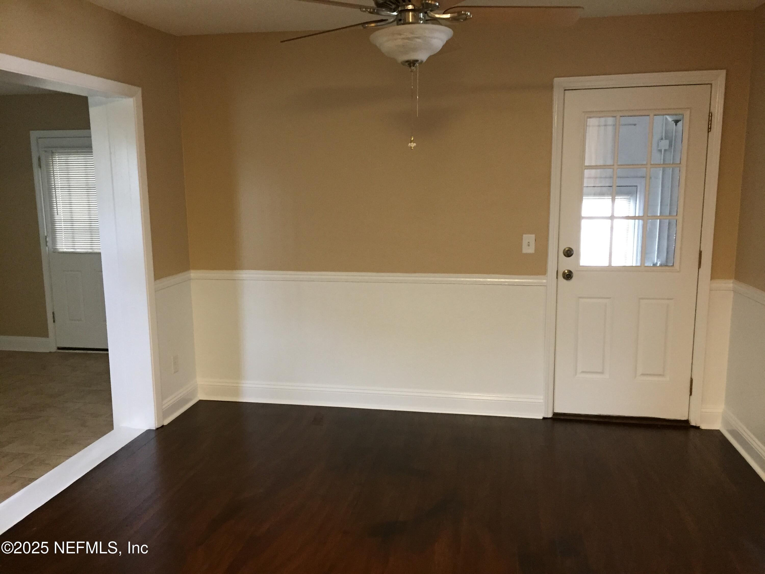 6938 Corkwood Road Jacksonville, FL 32277 - Photo 13 of 25 an empty room with a door