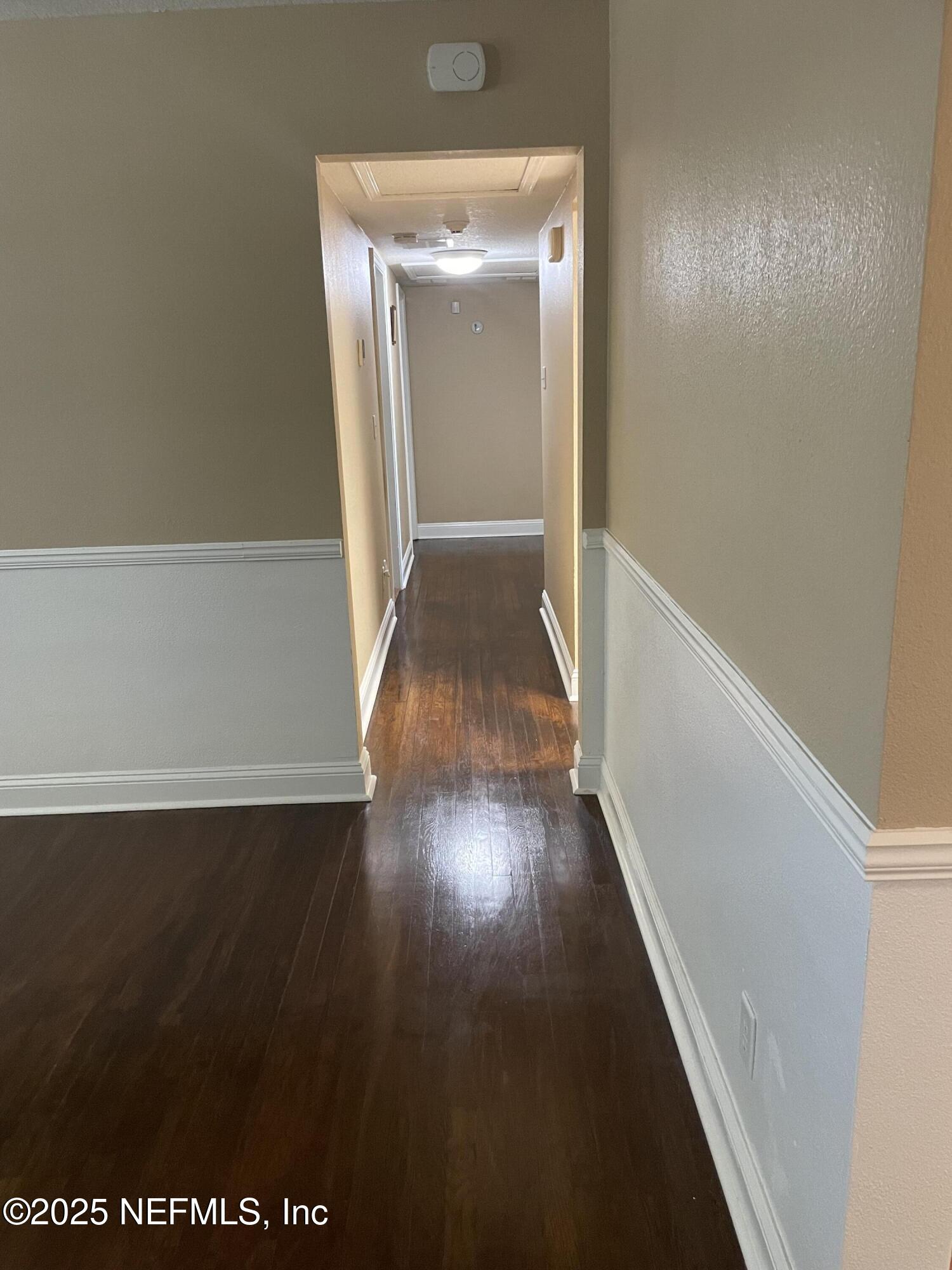 6938 Corkwood Road Jacksonville, FL 32277 - Photo 14 of 25 a view of a hallway with wooden floor