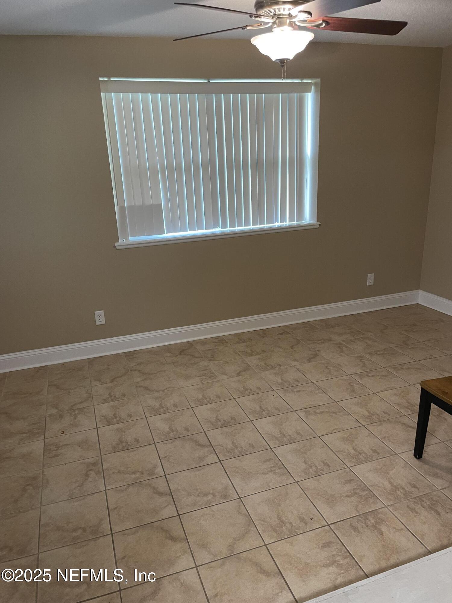 6938 Corkwood Road Jacksonville, FL 32277 - Photo 16 of 25 an empty room with windows