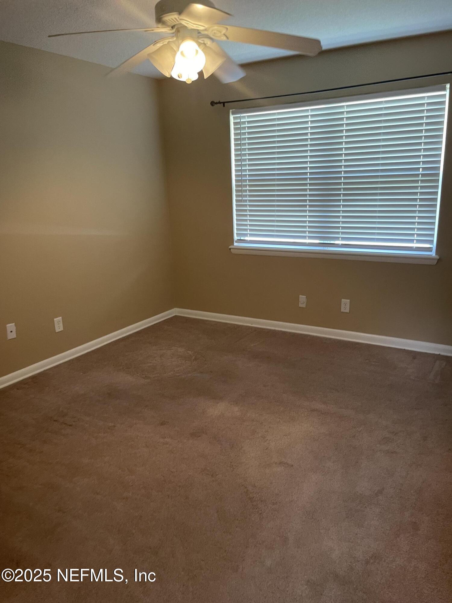 6938 Corkwood Road Jacksonville, FL 32277 - Photo 18 of 25 a view of empty room with window