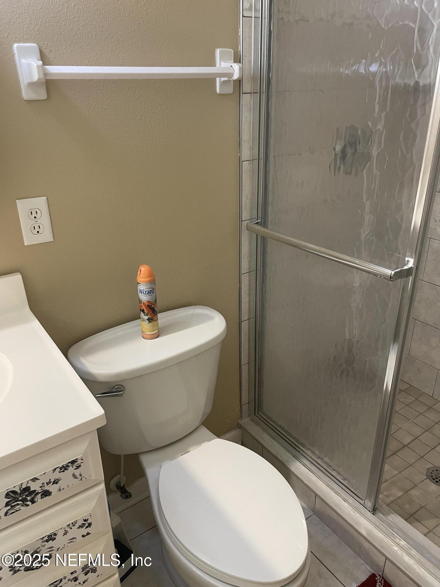 6938 Corkwood Road Jacksonville, FL 32277 - Photo 20 of 25 a white toilet sitting next to a bathroom sink