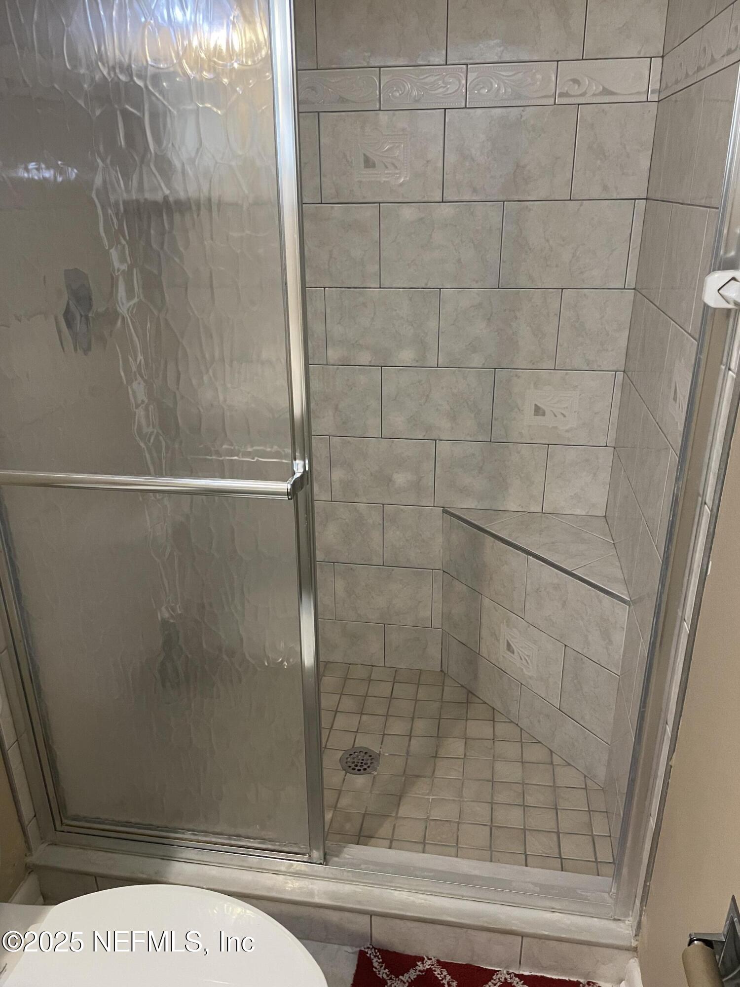 6938 Corkwood Road Jacksonville, FL 32277 - Photo 21 of 25 a bathroom with a shower