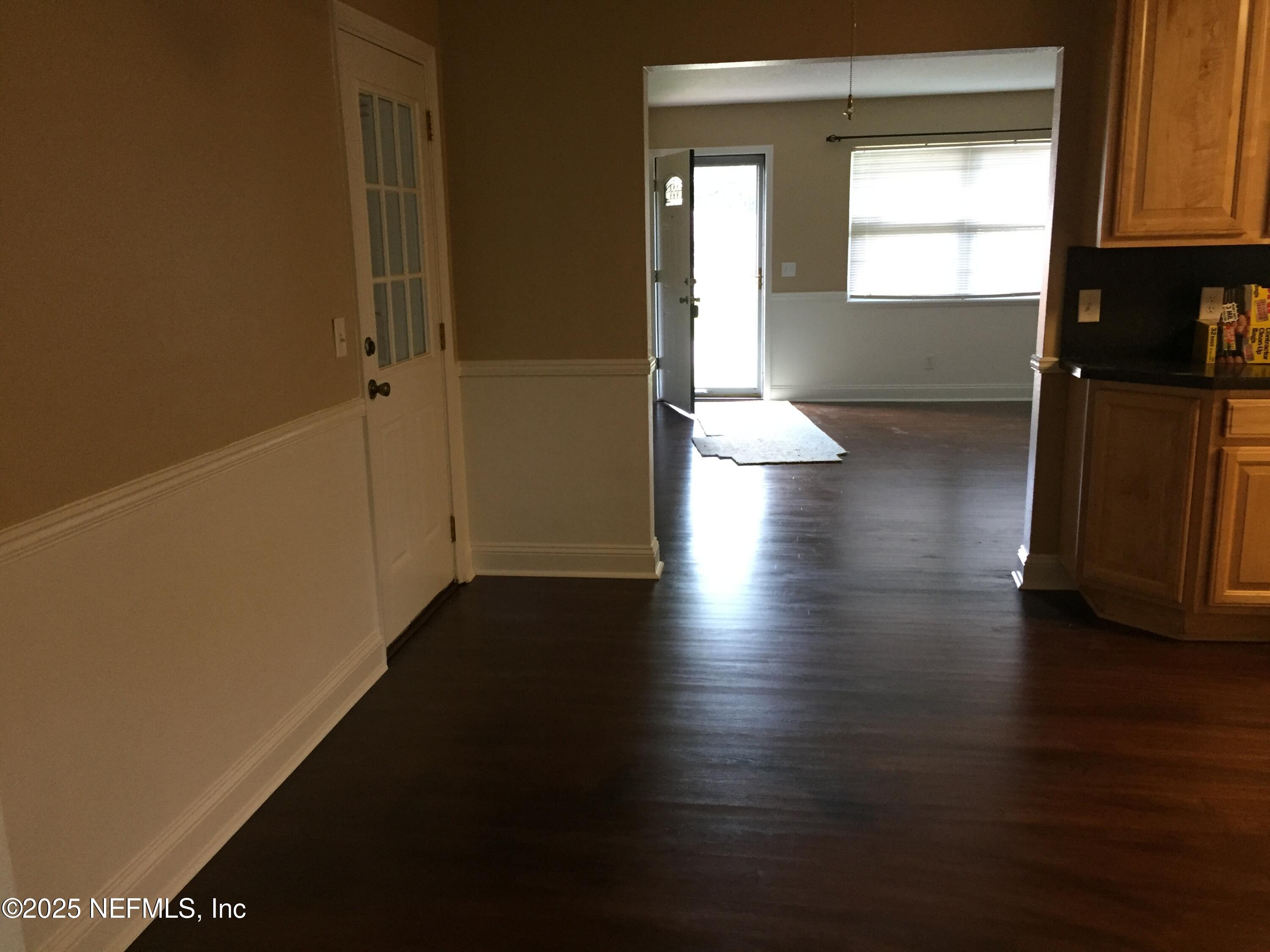 6938 Corkwood Road Jacksonville, FL 32277 - Photo 10 of 25 a view of a hallway with wooden floor and a window
