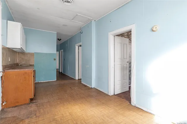 an empty room with a window and a mirror