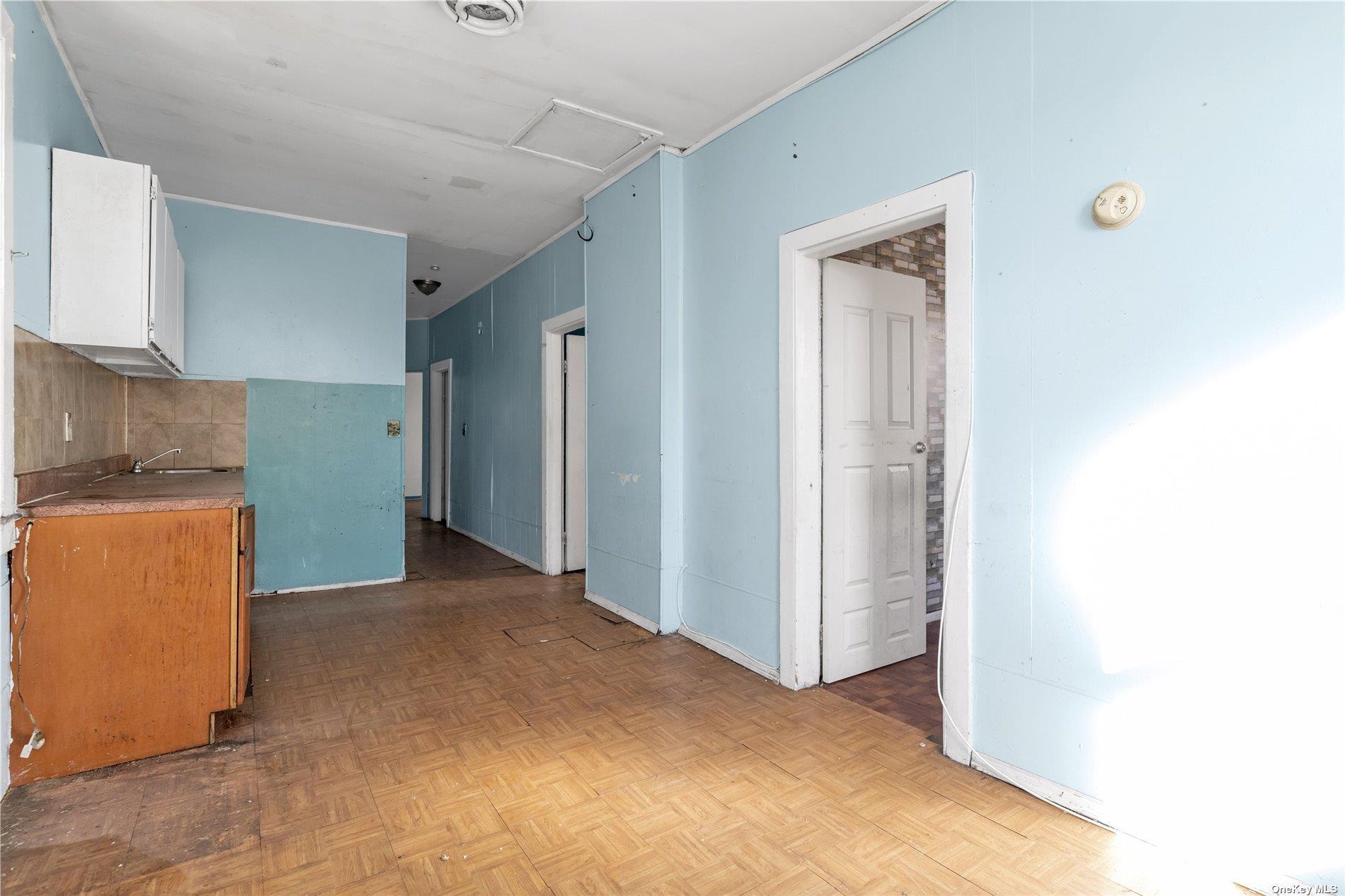 111-24 Northern Boulevard Queens, NY 11368 - Photo 14 of 29 a view of a kitchen with wooden cabinets and a refrigerator