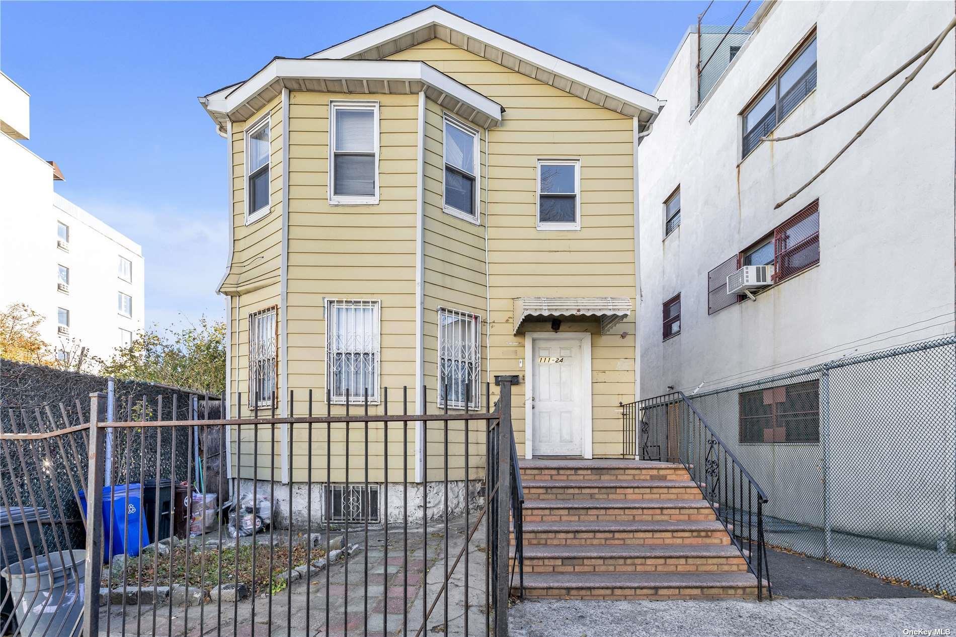 111-24 Northern Boulevard Queens, NY 11368 - Photo 9 of 29 a front view of a house with wooden fence