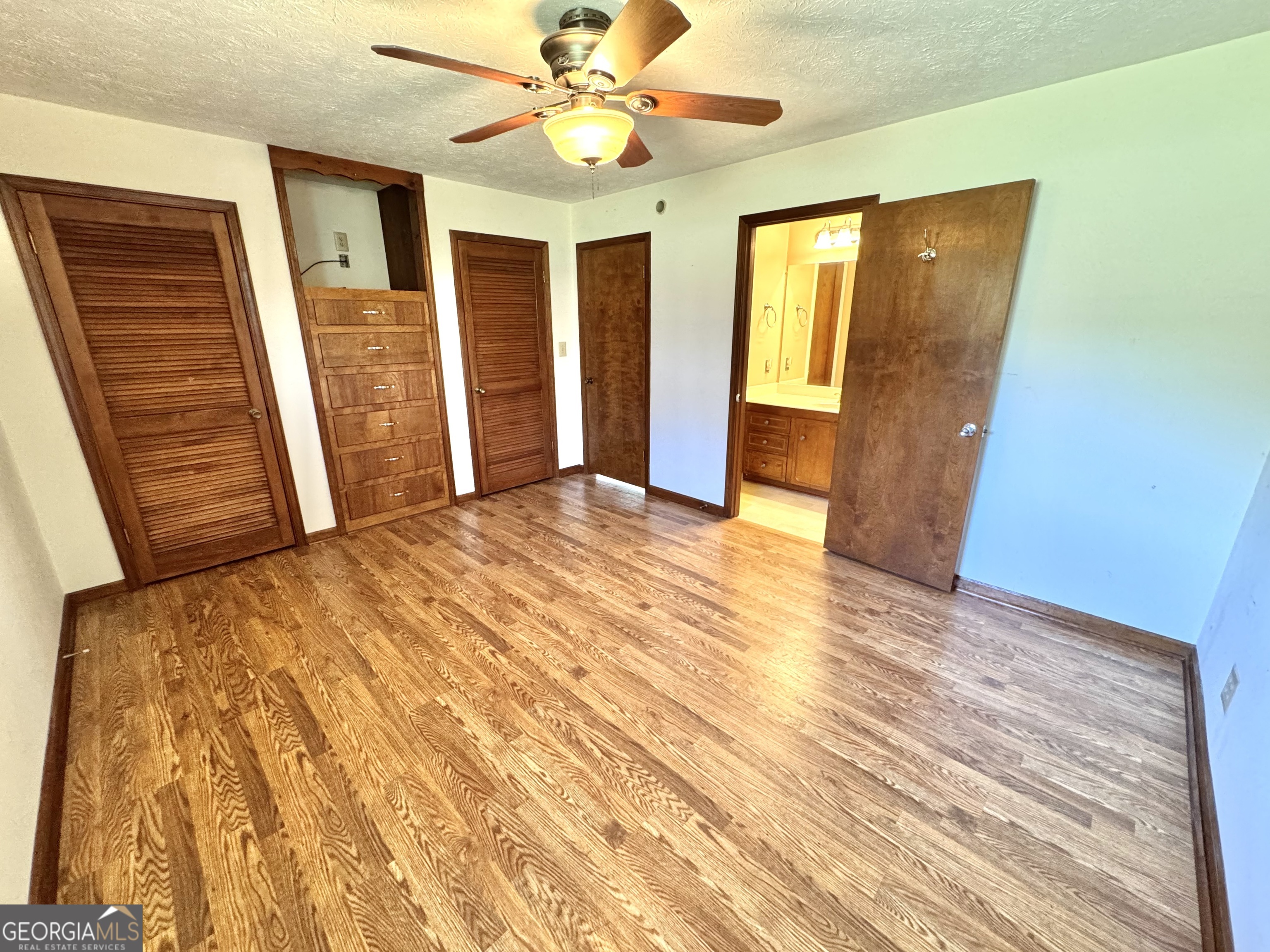1760 Fears Road Rutledge, GA 30663 - Photo 25 of 68 a view of an empty room with wooden floor and a ceiling fan