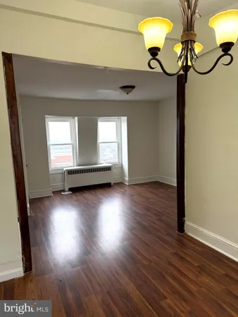 a view of room with window and wooden floor