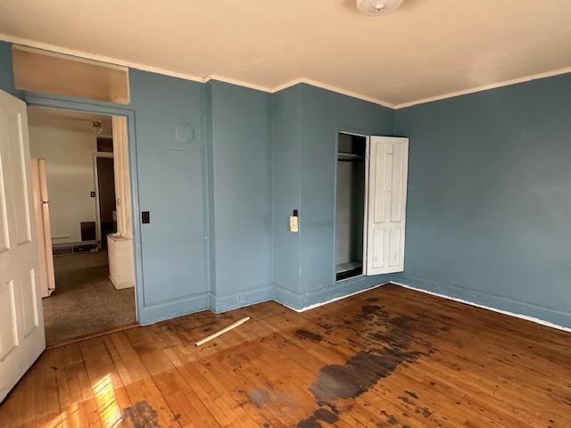 412 Monroe Street Eveleth, MN 55734 - Photo 16 of 22 Unfurnished bedroom with a closet, crown molding, and hardwood / wood-style flooring