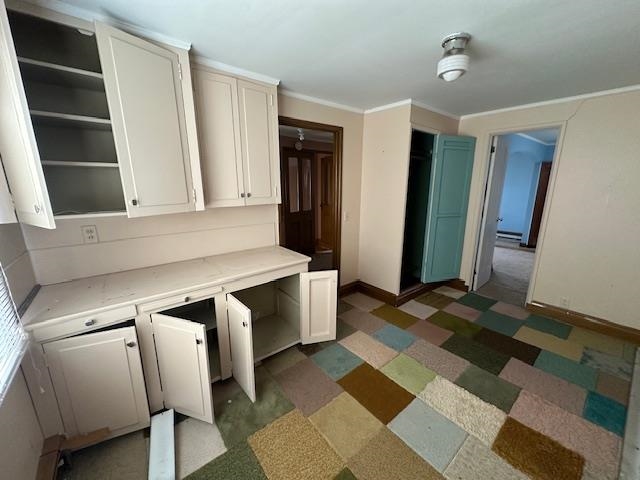 412 Monroe Street Eveleth, MN 55734 - Photo 3 of 22 Kitchen featuring ornamental molding, white cabinets, and dark colored carpet