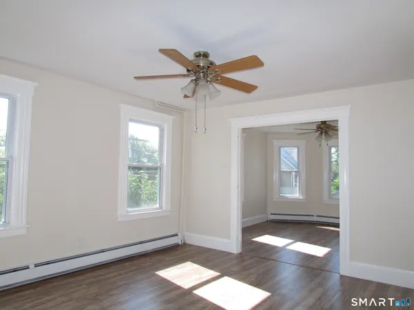 wooden floor in an empty room with a window