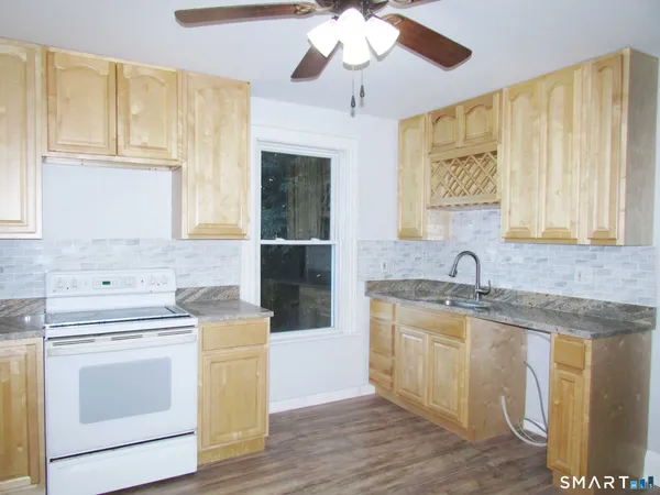 a kitchen with a stove sink and cabinets