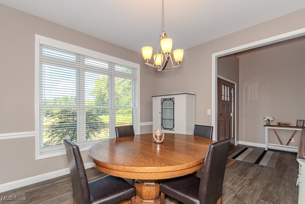 8675 Auburn Road Chardon, OH 44024 - Photo 8 of 35 Dining space with a chandelier and dark wood-type flooring