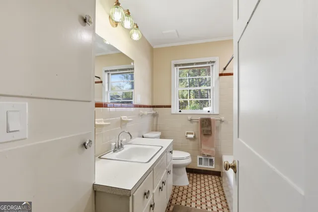 a bathroom with a sink a vanity and a mirror