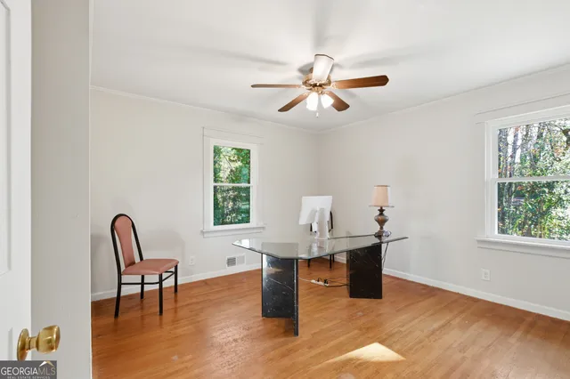 a workspace with furniture window and wooden floor