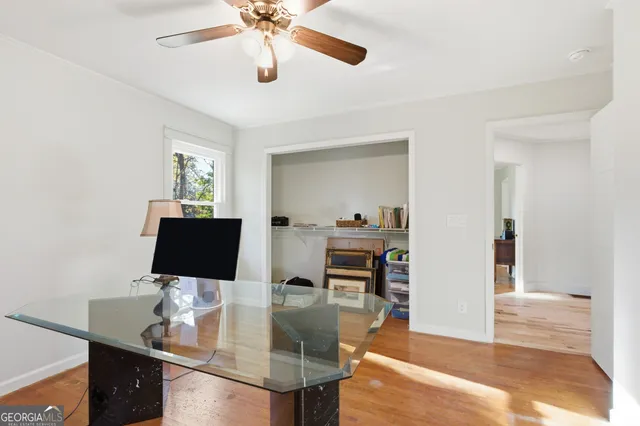 a view of a workspace with furniture and a window