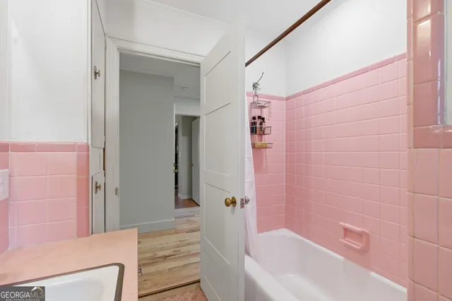 a bathroom with a bathtub and shower